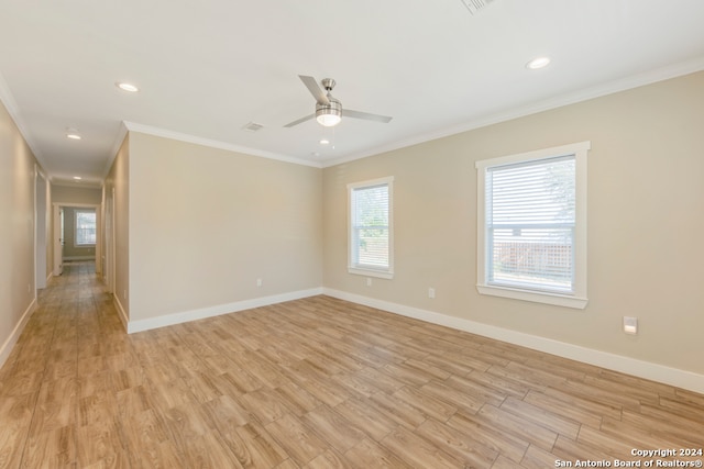 empty room with ceiling fan, ornamental molding, and light hardwood / wood-style flooring