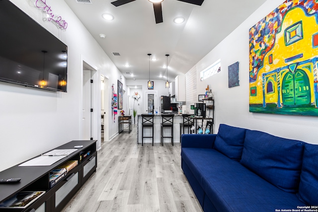 living room featuring ceiling fan and light hardwood / wood-style flooring