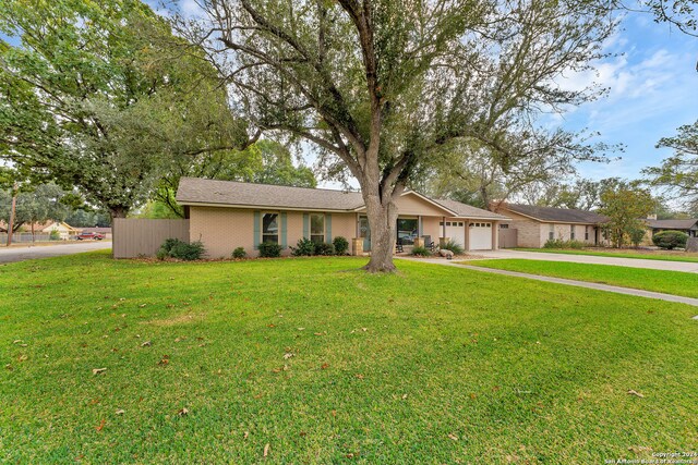 ranch-style home featuring a garage and a front yard