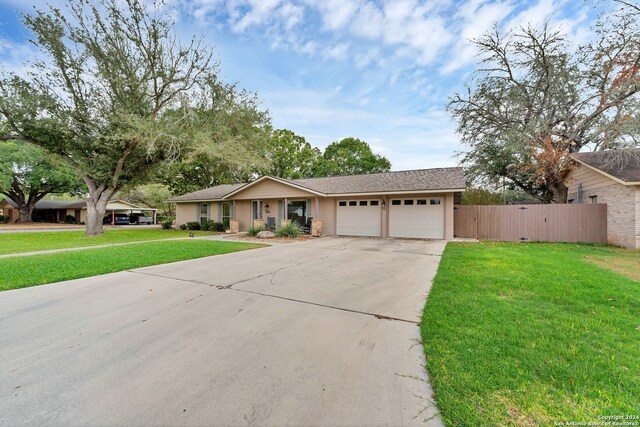 ranch-style house with a garage and a front lawn