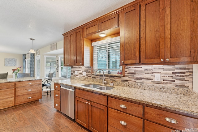 kitchen with dishwasher, a healthy amount of sunlight, sink, and light hardwood / wood-style flooring