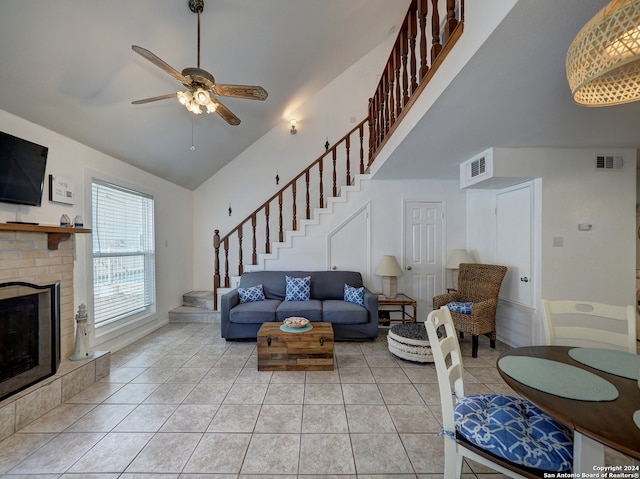 tiled living room with high vaulted ceiling and ceiling fan