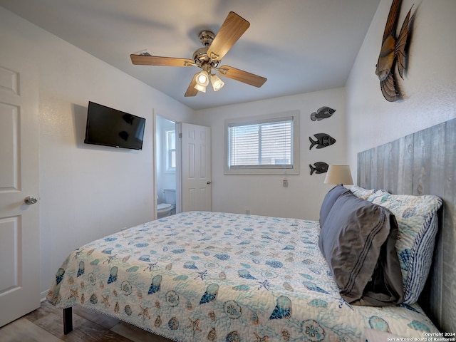 bedroom with ensuite bathroom, ceiling fan, and wood-type flooring