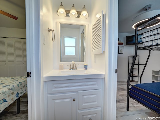 bathroom featuring vanity, hardwood / wood-style flooring, and ceiling fan