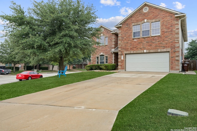 view of front of house with a garage and a front lawn