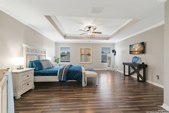 bedroom with dark wood-type flooring, ceiling fan, and a raised ceiling