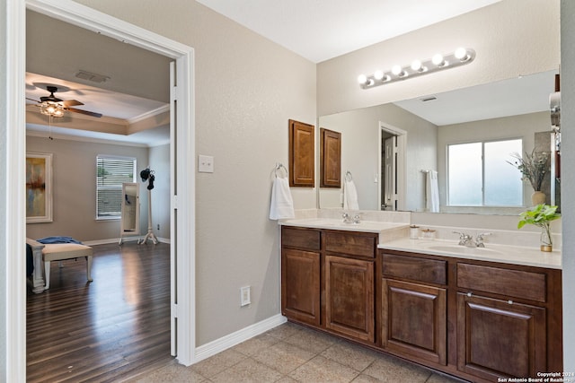 bathroom with hardwood / wood-style floors, plenty of natural light, vanity, and crown molding