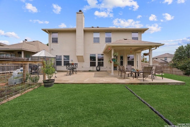 rear view of house featuring a patio and a yard