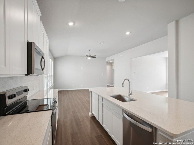 kitchen with stainless steel appliances, white cabinetry, and sink