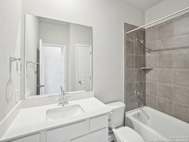 full bathroom featuring vanity, toilet, and tiled shower / bath combo