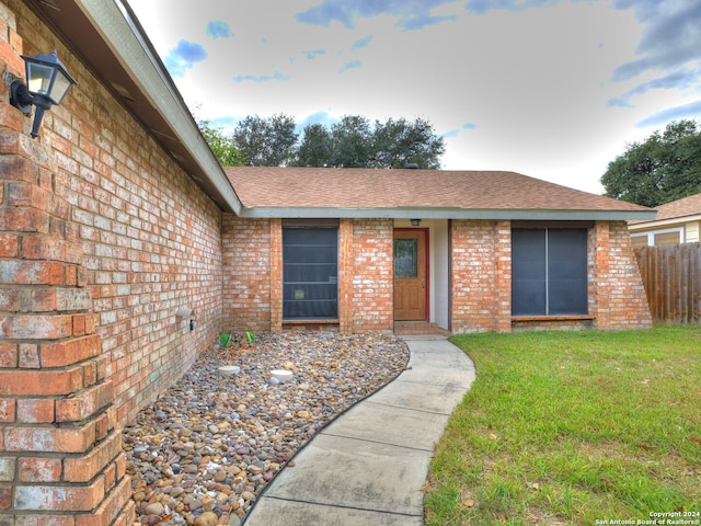 property entrance with a yard