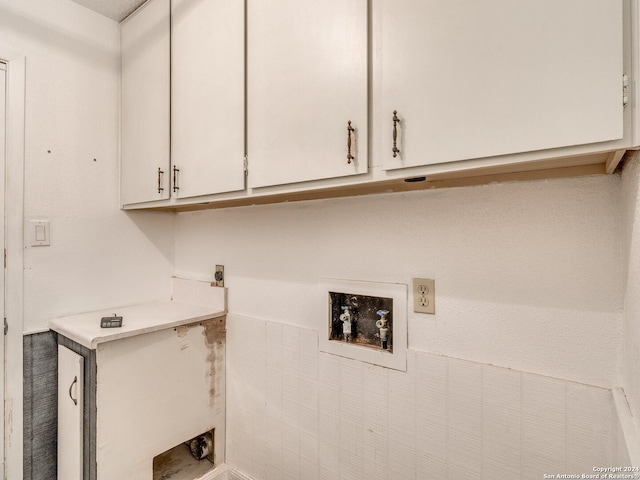 laundry area with washer hookup, electric dryer hookup, and cabinets