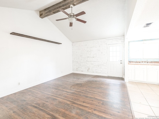 unfurnished room with beam ceiling, ceiling fan, high vaulted ceiling, brick wall, and hardwood / wood-style flooring