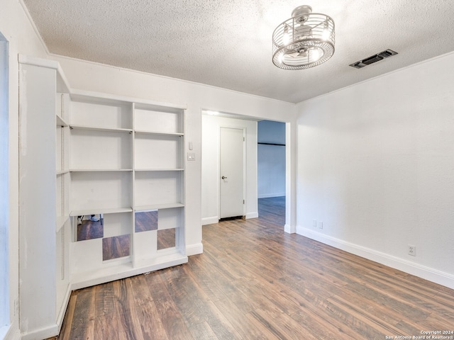 unfurnished bedroom featuring dark hardwood / wood-style flooring and a textured ceiling