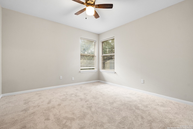 spare room with carpet floors and ceiling fan