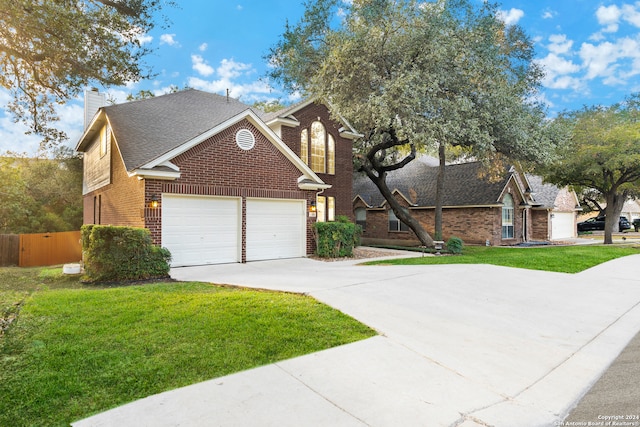 view of front of home with a front lawn and a garage