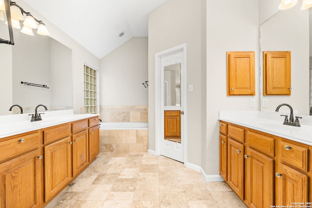 bathroom featuring tiled bath, high vaulted ceiling, and vanity