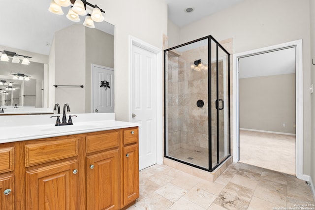 bathroom with a shower with shower door and vanity