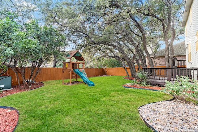 view of yard with a playground and a wooden deck