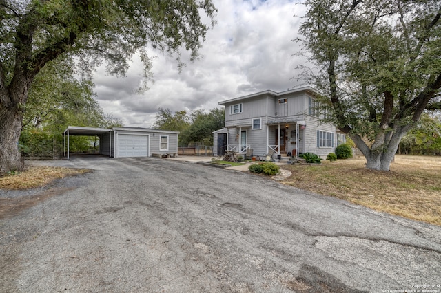 view of front of property with a garage, a porch, and a front yard