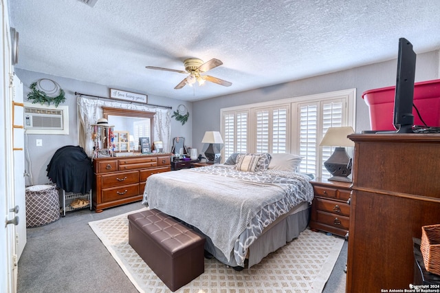 360 Benson Rd, Uvalde, TX 78801 - bedroom with carpet flooring, a textured ceiling, a ceiling fan, and a wall mounted AC