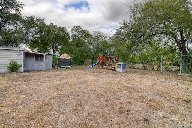 360 Benson Rd, Uvalde, TX 78801 - view of yard featuring a playground, fence, and view of wooded area