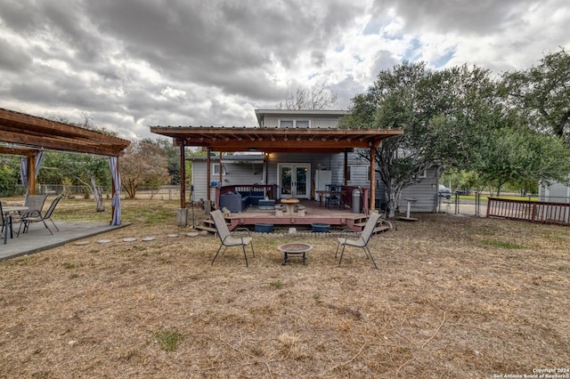 360 Benson Rd, Uvalde, TX 78801 - rear view of house featuring a fire pit, french doors, a deck, and a fenced backyard