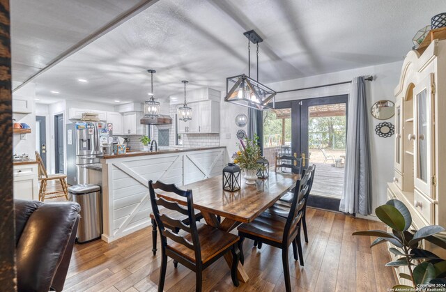 360 Benson Rd, Uvalde, TX 78801 - dining room featuring french doors, light wood-style flooring, and recessed lighting