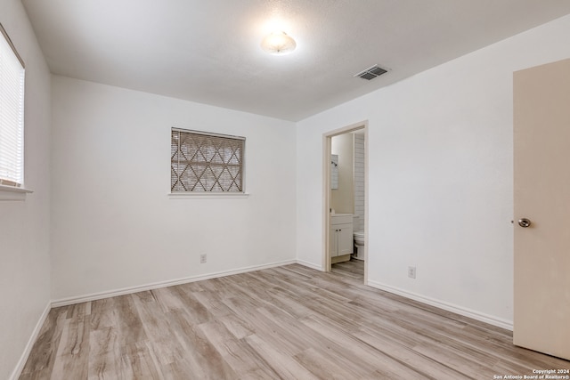 spare room featuring light wood-type flooring