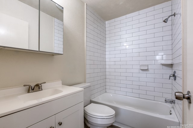 full bathroom featuring toilet, vanity, and tiled shower / bath