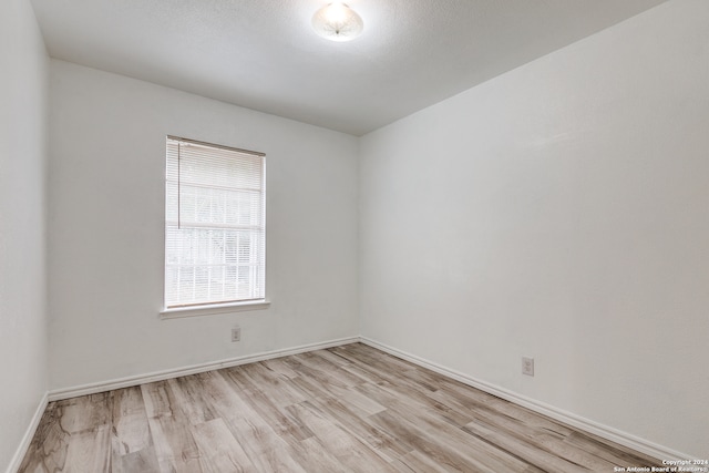 unfurnished room with light hardwood / wood-style floors