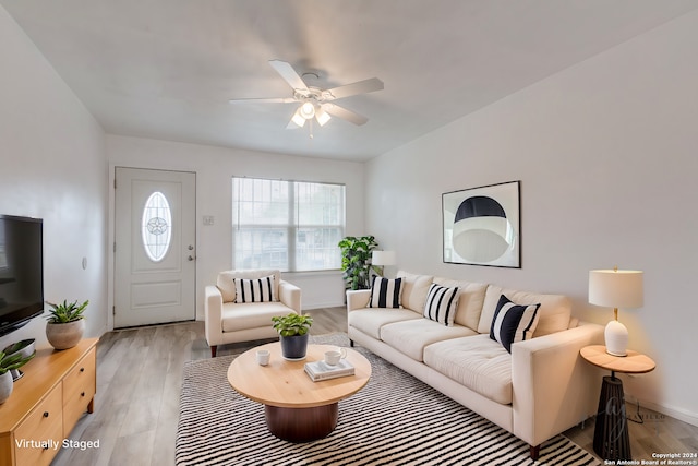 living room featuring ceiling fan and light hardwood / wood-style floors