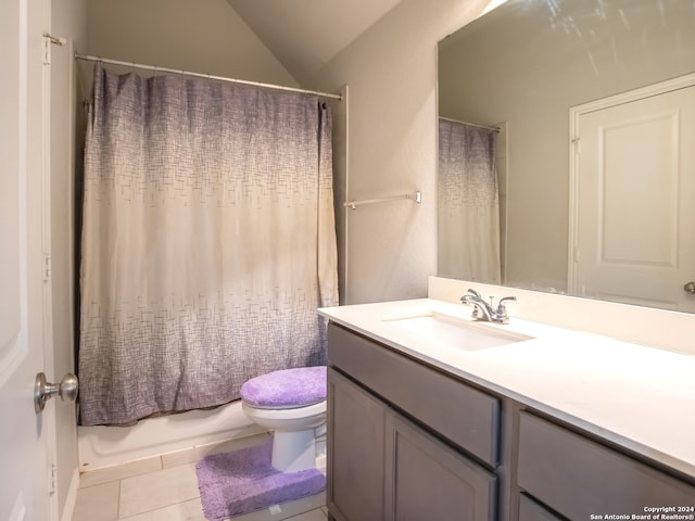 full bathroom featuring tile patterned floors, vanity, vaulted ceiling, toilet, and shower / bathtub combination with curtain