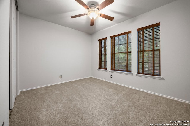 carpeted empty room with ceiling fan