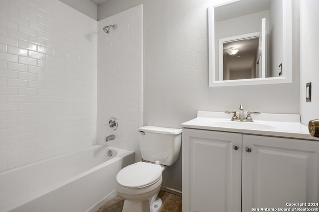 full bathroom with tile patterned floors, vanity, tiled shower / bath combo, and toilet