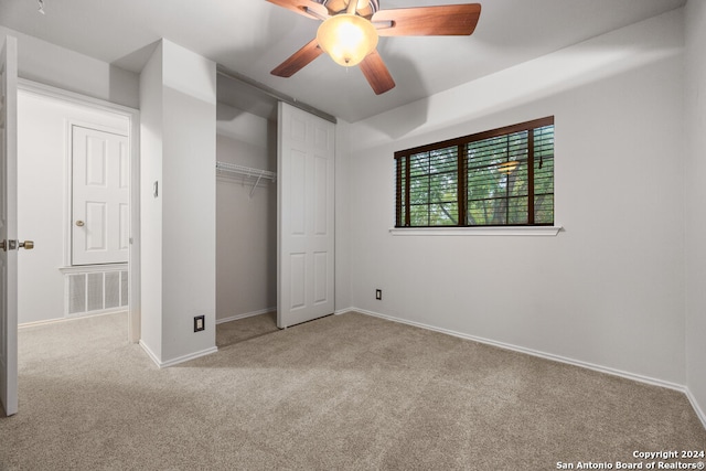 unfurnished bedroom with ceiling fan, a closet, and light colored carpet