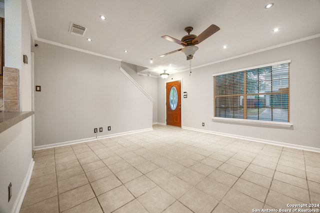 tiled empty room with ceiling fan and crown molding