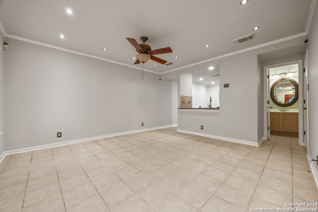 empty room with ceiling fan, sink, light tile patterned floors, and ornamental molding