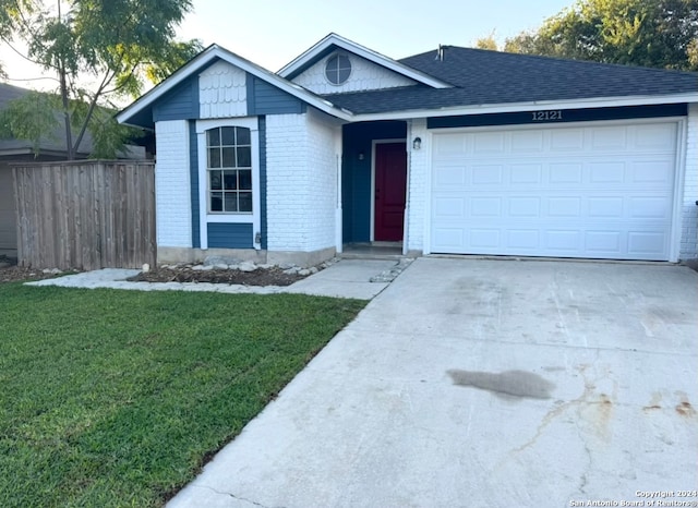 view of front of home featuring a garage and a front lawn