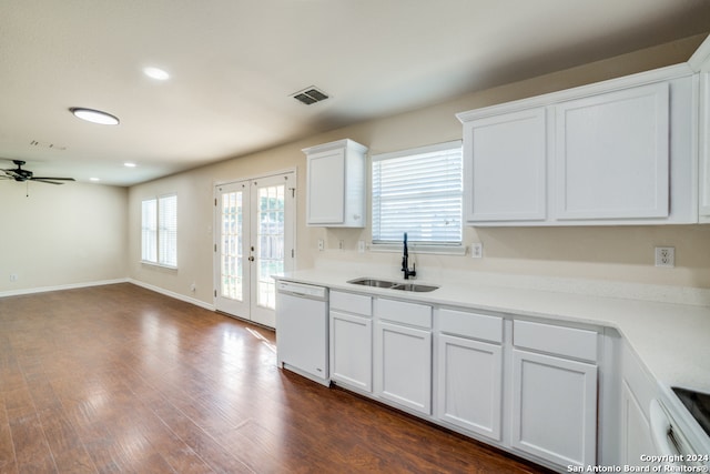 kitchen with white dishwasher, white cabinets, sink, and dark hardwood / wood-style flooring