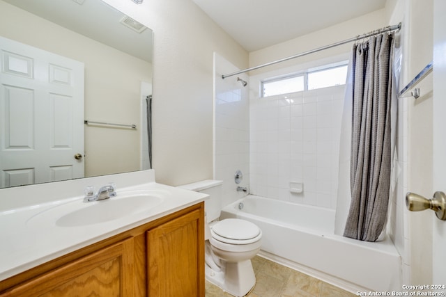 full bathroom with vanity, tile patterned floors, toilet, and shower / tub combo