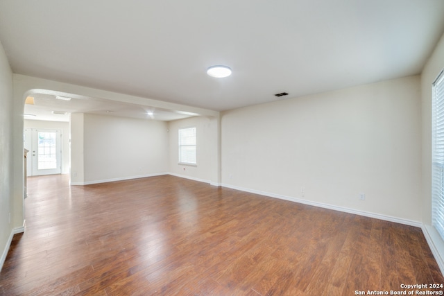 unfurnished room featuring hardwood / wood-style flooring and a healthy amount of sunlight