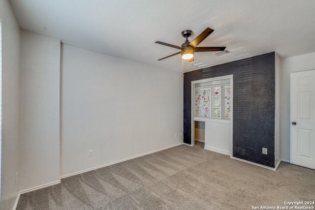 unfurnished bedroom featuring ceiling fan and light colored carpet