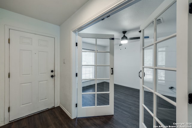 foyer entrance with french doors, ceiling fan, and dark hardwood / wood-style flooring