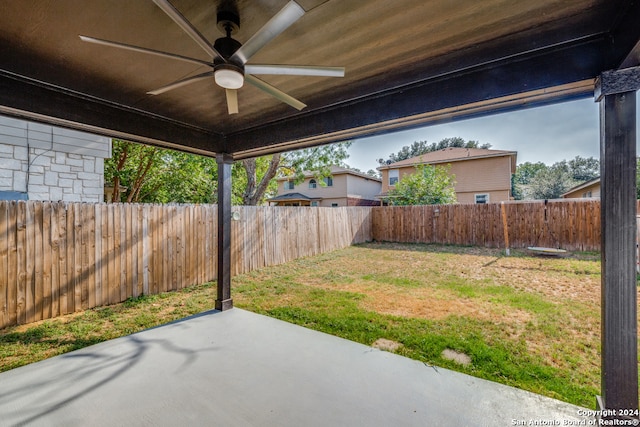 view of yard featuring ceiling fan and a patio