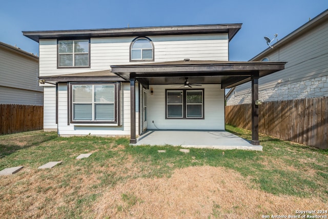 rear view of property with a lawn, ceiling fan, and a patio