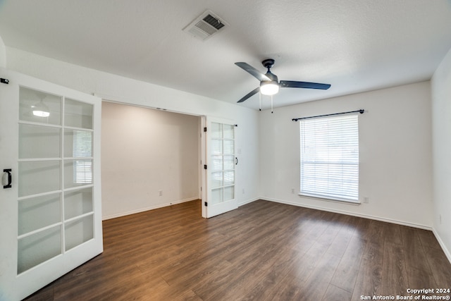 unfurnished room featuring ceiling fan, french doors, a textured ceiling, and dark hardwood / wood-style flooring