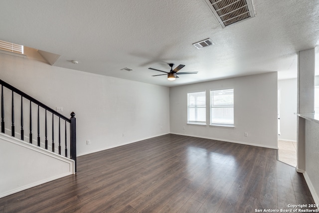 unfurnished living room featuring a textured ceiling, dark wood-type flooring, and ceiling fan