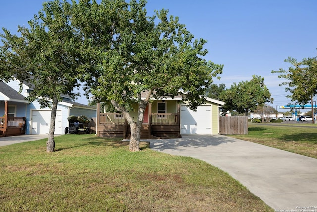 1403 S Young, Rockport, TX 78382 - view of front of home with covered porch, concrete driveway, and a garage