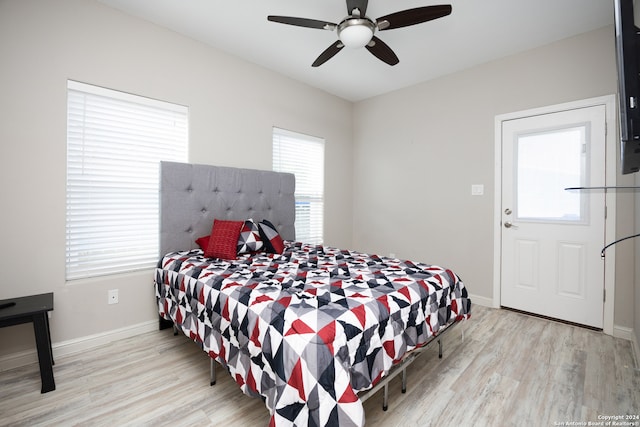 bedroom with light hardwood / wood-style floors and ceiling fan